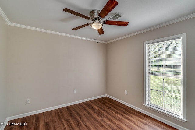 unfurnished room featuring dark wood finished floors, baseboards, visible vents, and a wealth of natural light