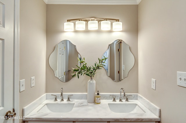 bathroom with double vanity, crown molding, and a sink