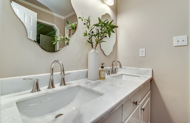 bathroom featuring double vanity, ornamental molding, and a sink