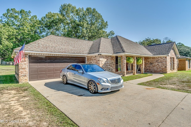 single story home with brick siding, a front yard, roof with shingles, a garage, and driveway