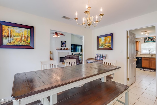 dining area with visible vents, ceiling fan with notable chandelier, and light tile patterned floors