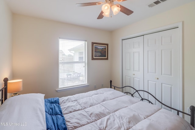 bedroom featuring visible vents, ceiling fan, and a closet