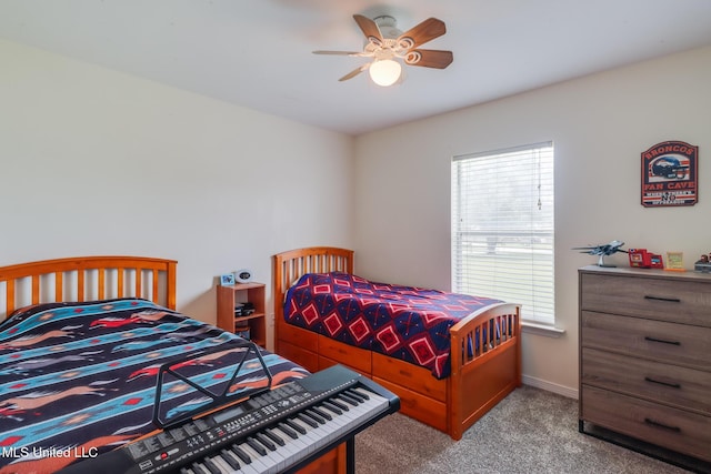 carpeted bedroom with baseboards and a ceiling fan