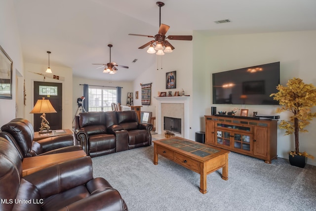living area with carpet floors, ceiling fan, a fireplace, and visible vents