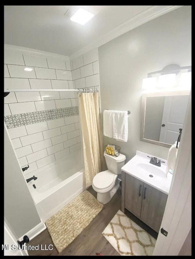 full bathroom with toilet, shower / bath combination with curtain, ornamental molding, hardwood / wood-style floors, and vanity