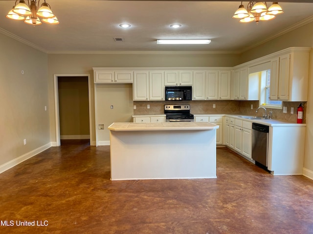 kitchen featuring white cabinets, hanging light fixtures, sink, crown molding, and stainless steel appliances