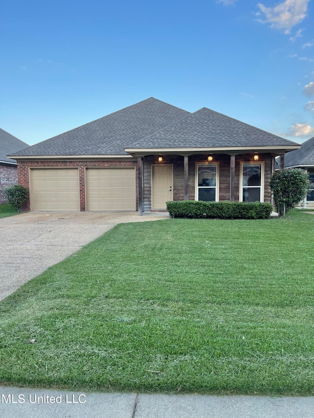 view of front of property with a garage and a front lawn