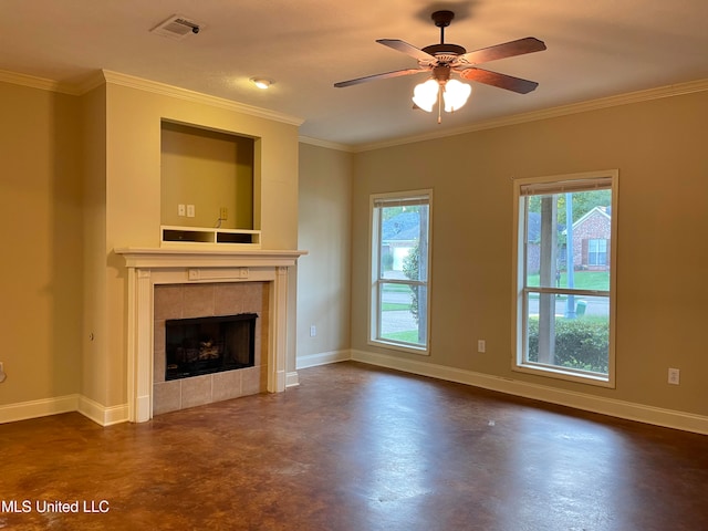 unfurnished living room featuring a tiled fireplace, ornamental molding, and ceiling fan