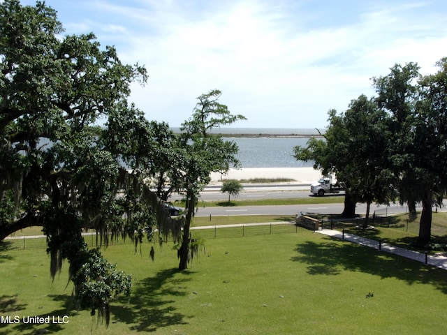 view of community featuring a lawn and a water view