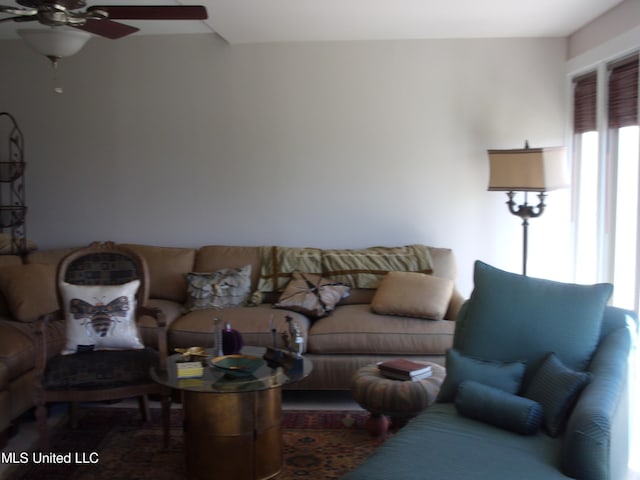 living room with ceiling fan and a healthy amount of sunlight