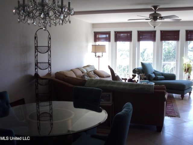 living room with tile patterned floors and ceiling fan with notable chandelier