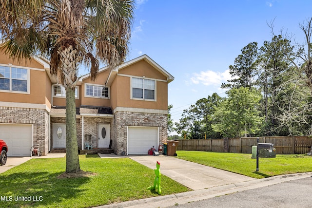 view of front of home featuring a front yard and a garage