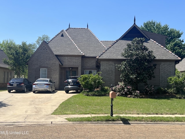 109 Brisage Dr, Madison, MS 39110 - french country home featuring concrete driveway, a front lawn, and brick siding