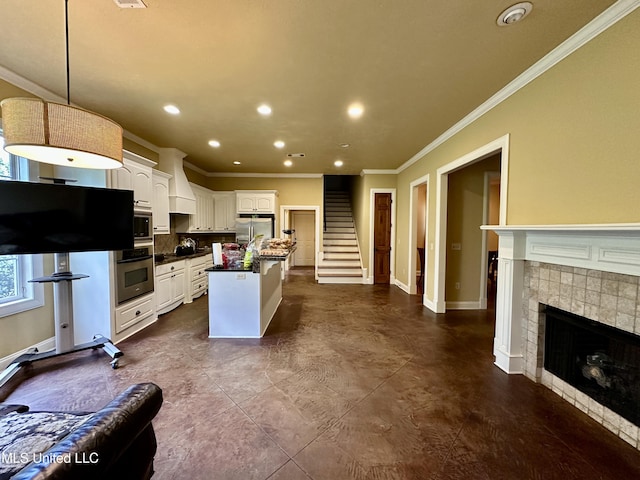 109 Brisage Dr, Madison, MS 39110 - kitchen featuring custom exhaust hood, white cabinetry, crown molding, dark countertops, and stainless steel appliances