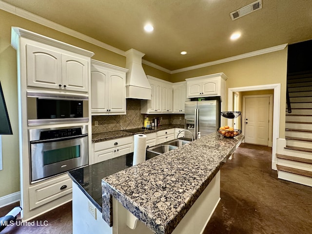 109 Brisage Dr, Madison, MS 39110 - kitchen with custom range hood, crown molding, stainless steel refrigerator with ice dispenser, visible vents, and a sink