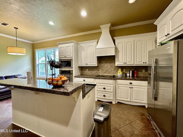 109 Brisage Dr, Madison, MS 39110 - kitchen with premium range hood, visible vents, white cabinets, and stainless steel refrigerator with ice dispenser