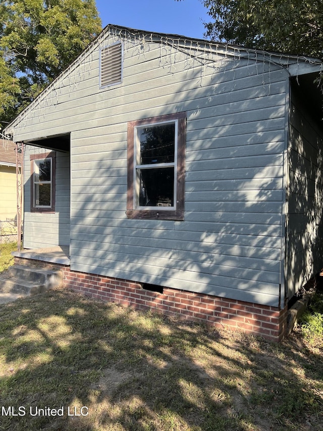 view of property exterior with a yard