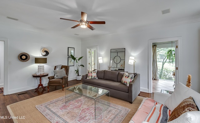 living room featuring ceiling fan, ornamental molding, and dark hardwood / wood-style flooring