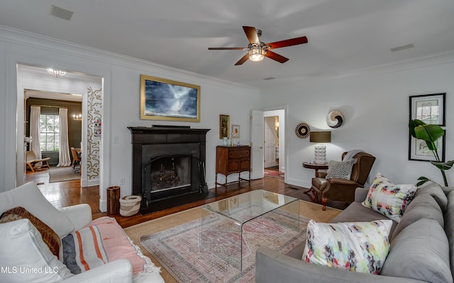 living room featuring hardwood / wood-style flooring, ornamental molding, and ceiling fan