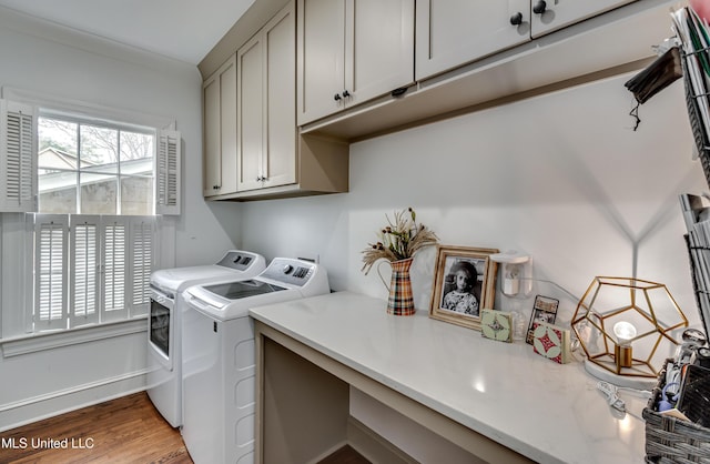 clothes washing area featuring cabinets, dark hardwood / wood-style flooring, and washing machine and dryer