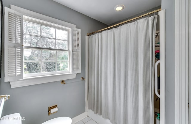 bathroom with shower / bath combination with curtain and toilet