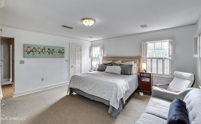 bedroom with ornamental molding and carpet floors