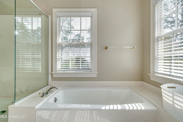 bathroom with independent shower and bath and plenty of natural light