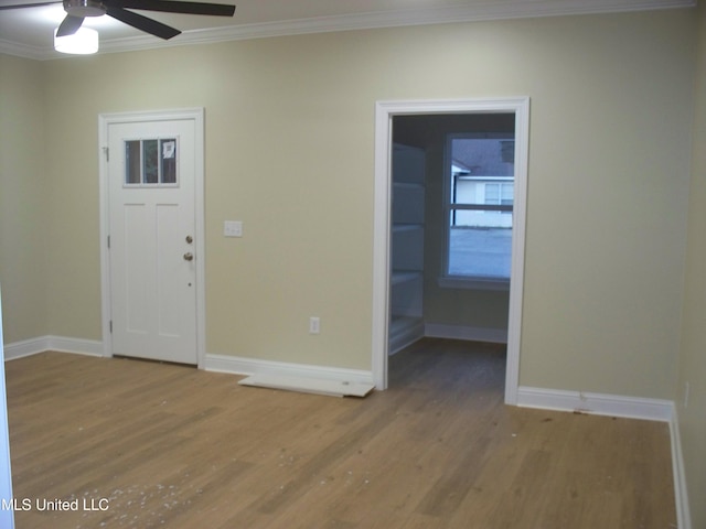 entryway with ceiling fan, ornamental molding, and hardwood / wood-style floors