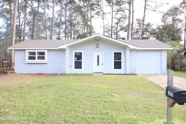 ranch-style home with a front yard, brick siding, concrete driveway, a garage, and board and batten siding