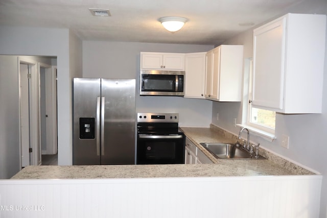 kitchen with visible vents, a sink, light countertops, white cabinets, and appliances with stainless steel finishes