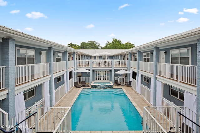 view of pool with an in ground hot tub and a patio