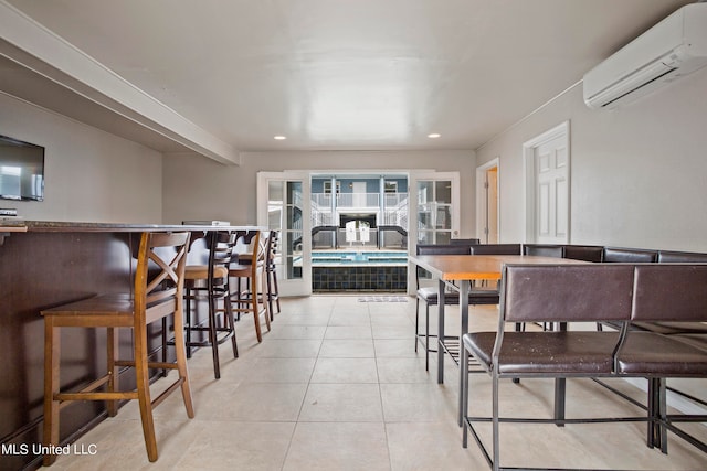 dining room featuring french doors, an AC wall unit, and light tile patterned floors