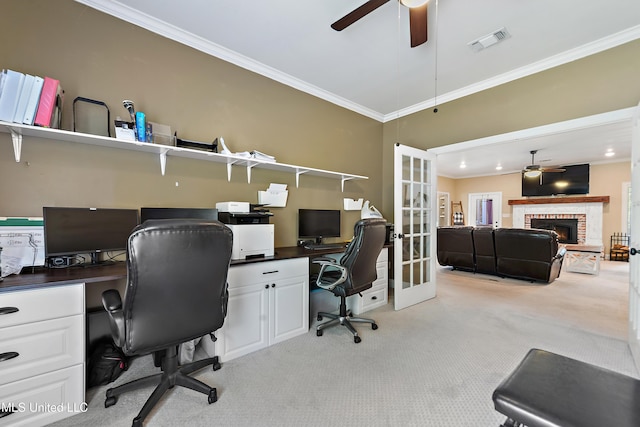 home office with light carpet, french doors, visible vents, a ceiling fan, and ornamental molding