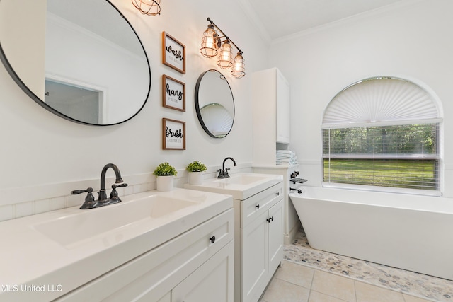 full bath featuring a freestanding bath, tile patterned flooring, ornamental molding, and a sink