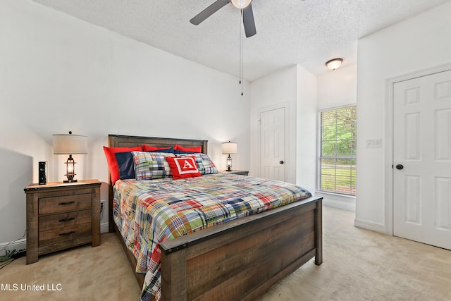bedroom with light carpet and a textured ceiling