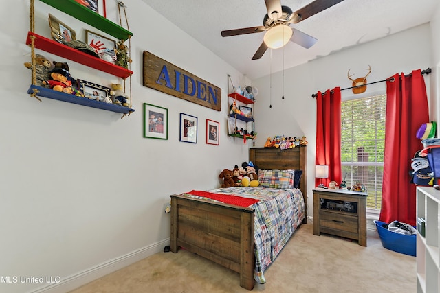 carpeted bedroom with baseboards and ceiling fan