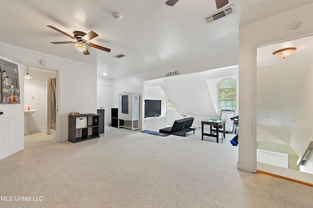 living area with light carpet, visible vents, and ceiling fan
