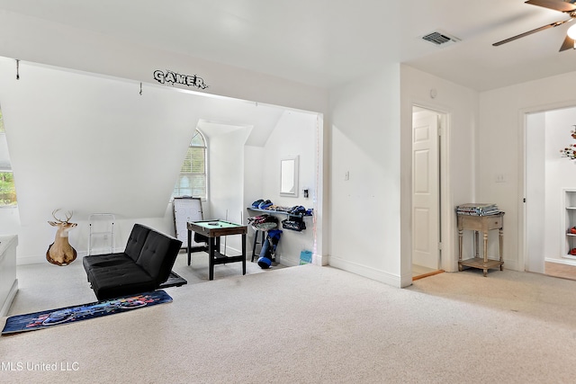 sitting room featuring visible vents, a ceiling fan, baseboards, and carpet