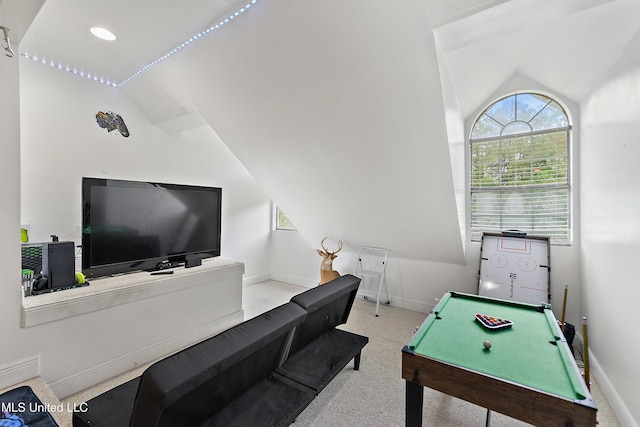 rec room featuring vaulted ceiling and baseboards