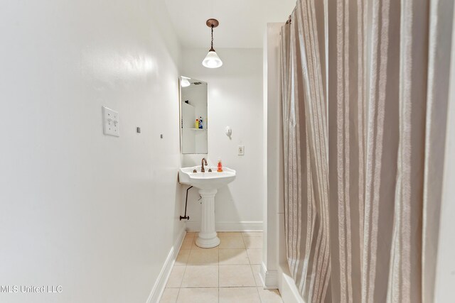 full bathroom with tile patterned floors and baseboards