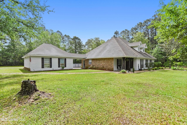 back of property with a lawn