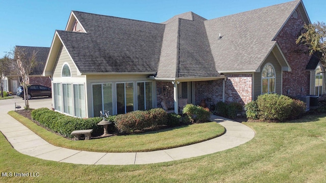 rear view of property with a lawn