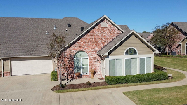 view of front facade with a front yard and a garage