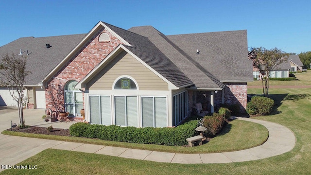 view of side of home featuring a yard and a garage