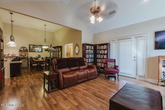 living room featuring ceiling fan, high vaulted ceiling, and dark hardwood / wood-style floors