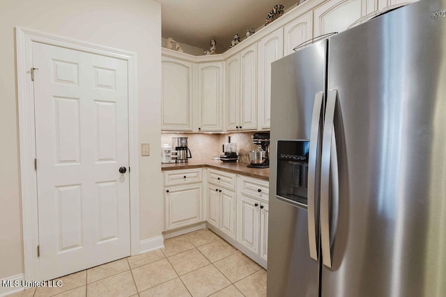 kitchen with stainless steel fridge, tasteful backsplash, and light tile patterned flooring