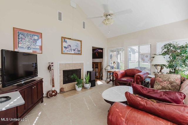 tiled living room featuring high vaulted ceiling, a tile fireplace, and ceiling fan