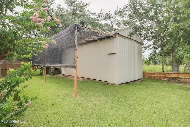 view of outbuilding with a yard