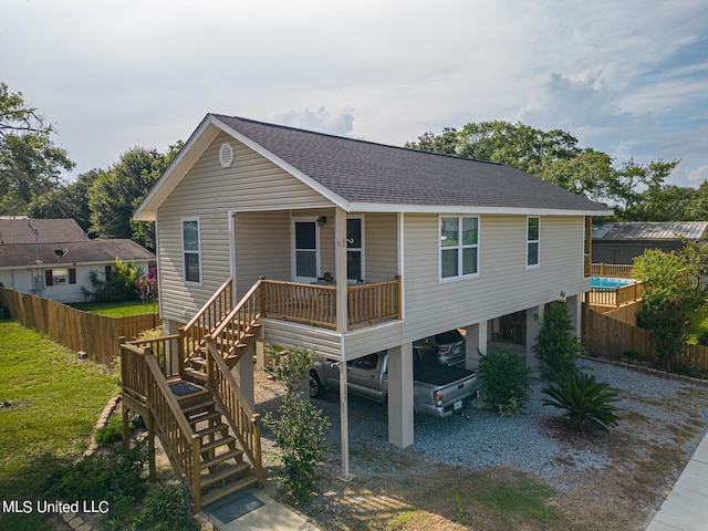 view of front of house with a porch and a carport