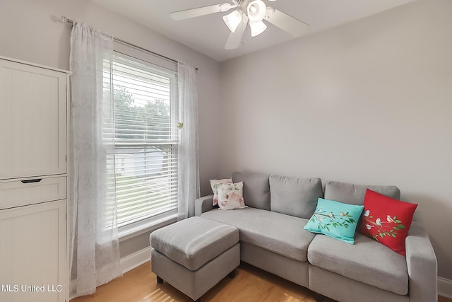 living room with plenty of natural light, light hardwood / wood-style floors, and ceiling fan